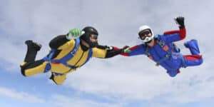 Three men jump out of a plane